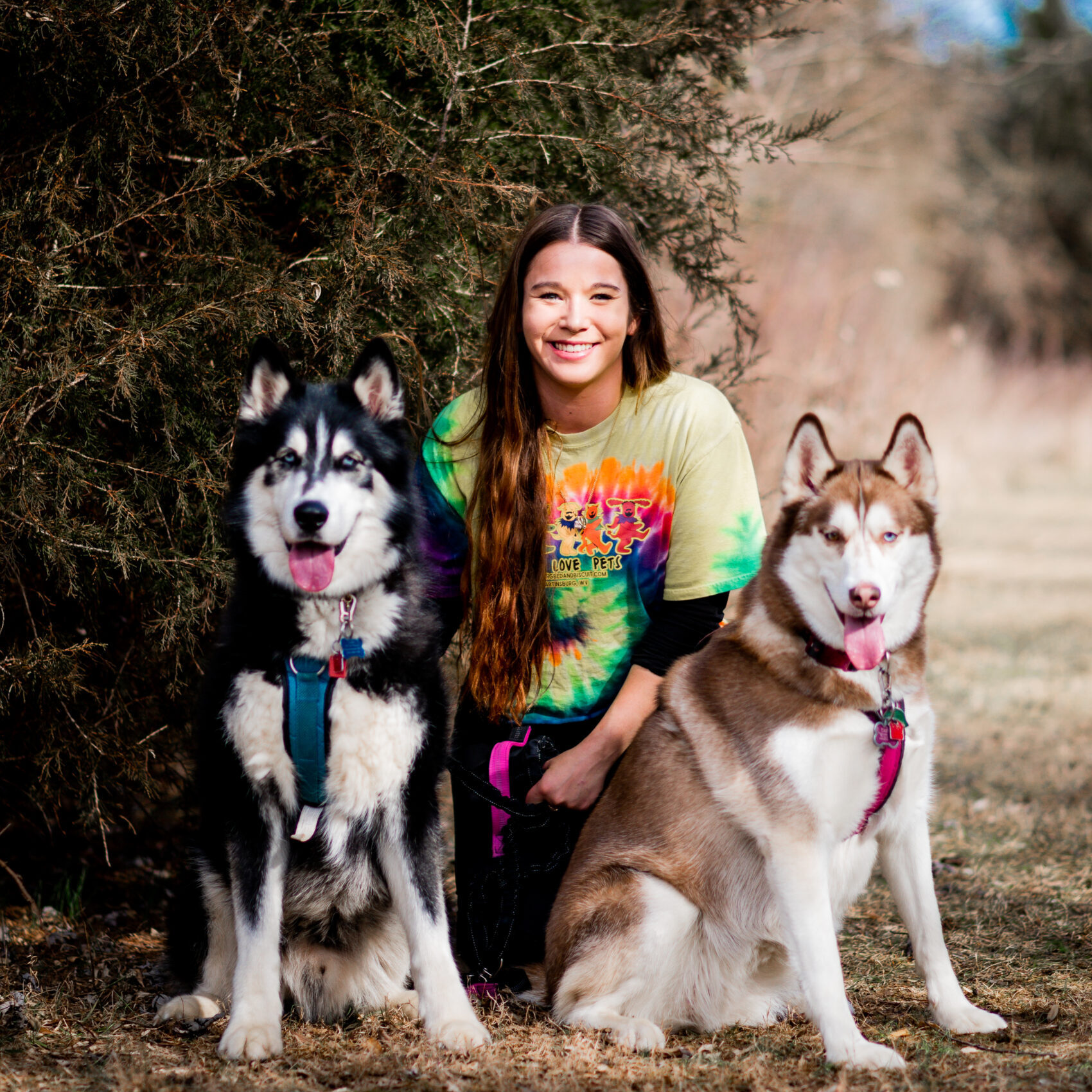 Kennel technician Sierra with her two personal dogs, Chief and Stella.