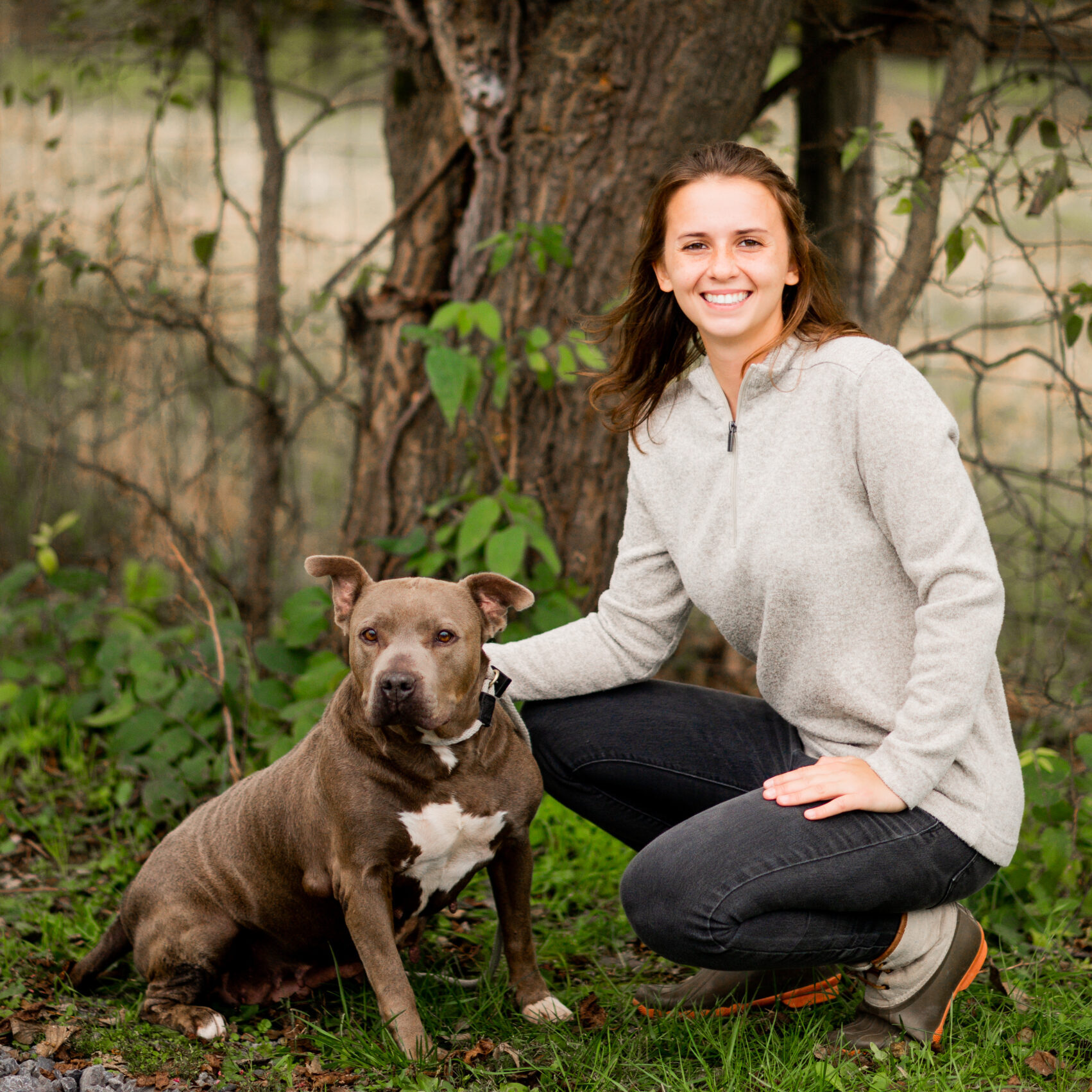Kennel technician Bre with adoptable dog Bonnie. Bonnie is being fostered by Greensburg Bed and Biscuit.