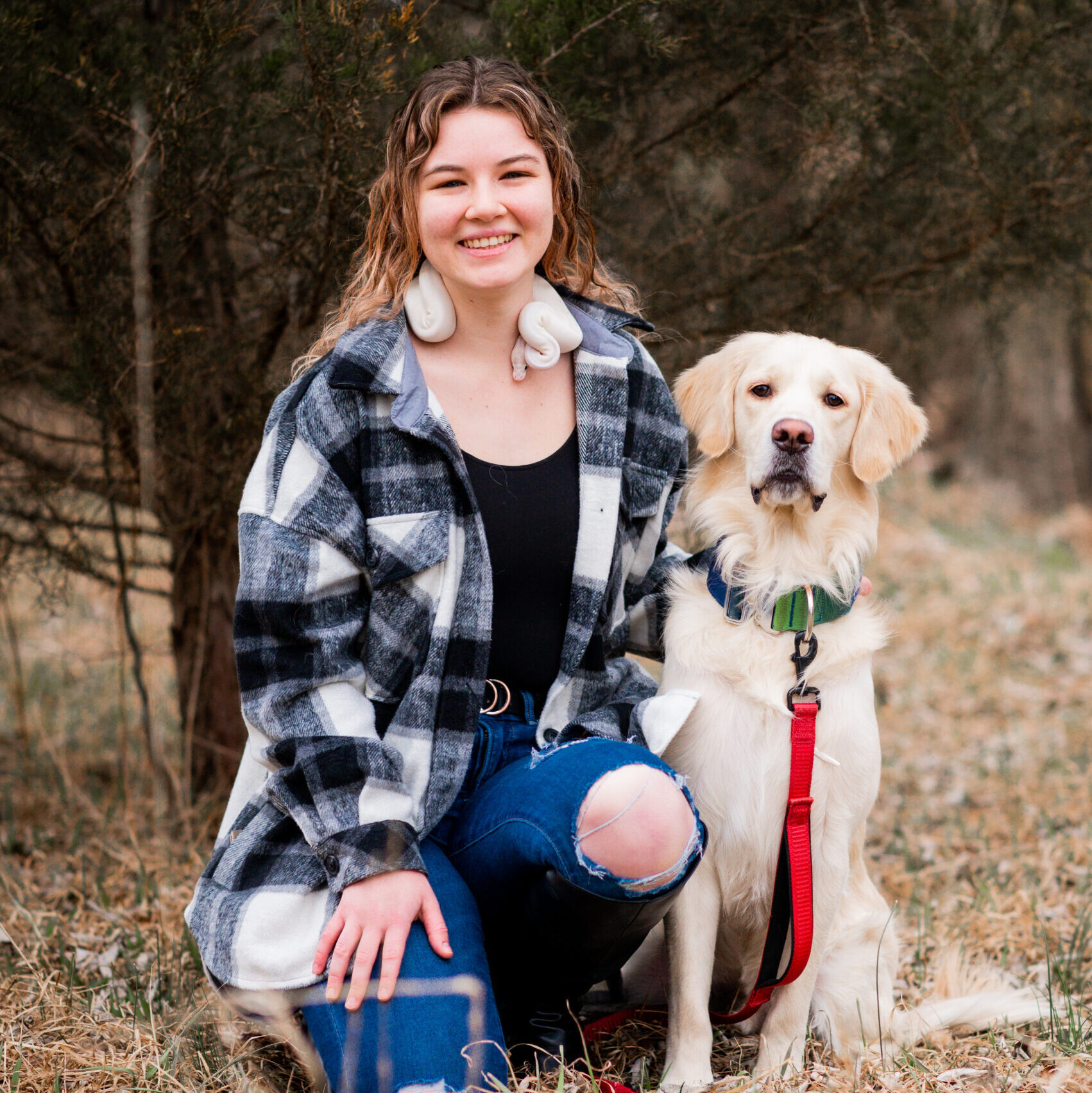 Dog groomer, Olivia, and her own dog Milo and her pet snake. Olivia is Greensburg Bed and Biscuit's newest dog groomer!